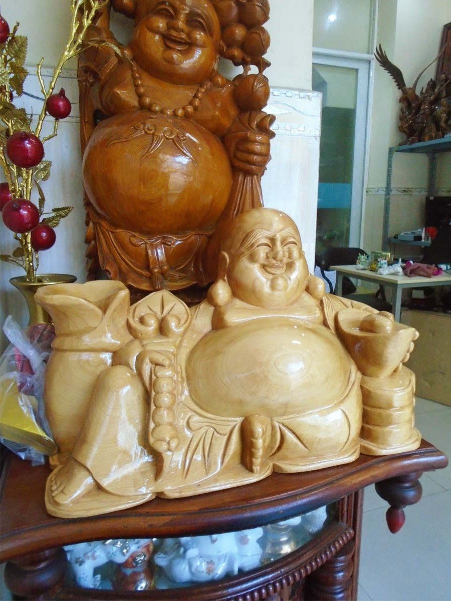 Tượng Phật Di Lặc được chạm khắc tinh xảo từ gỗ Pơ Mu, thể hiện đường vân và màu sắc tự nhiên của gỗ